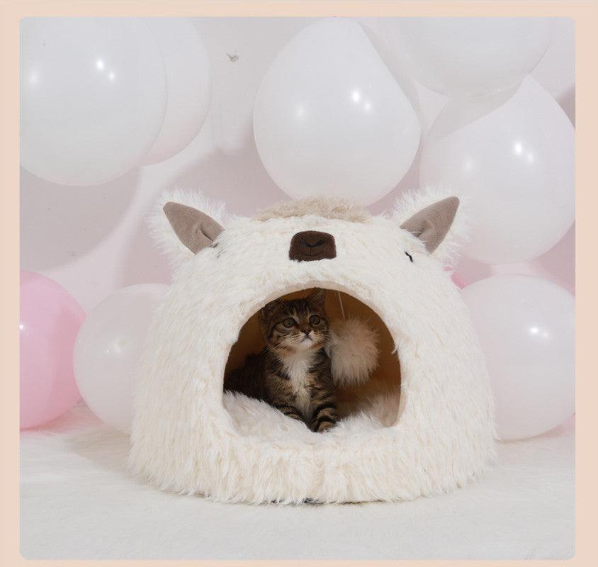 Cat inside a fluffy white pet cave with balloons in the background