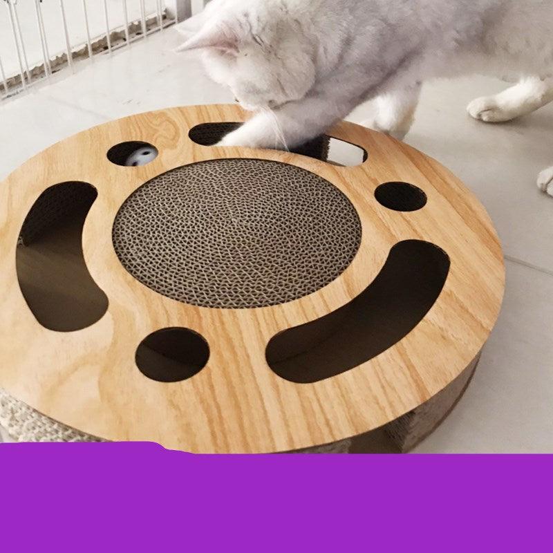 Cat playing with a wooden scratcher shaped like a smiley face.