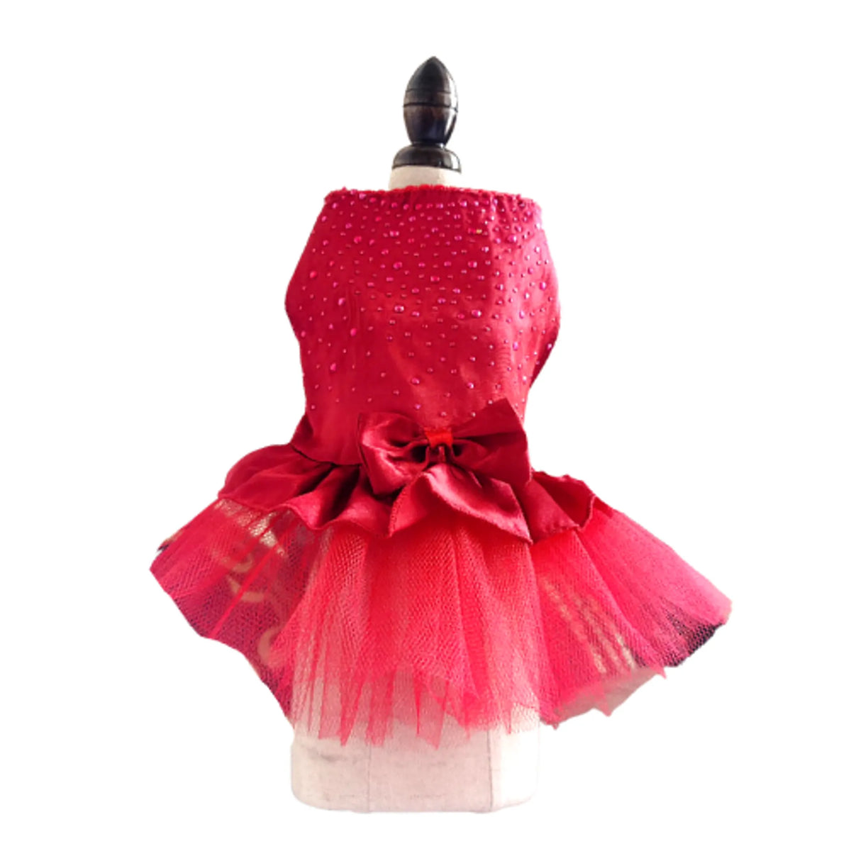 Red polka dot dress with a large bow on a mannequin against a white background