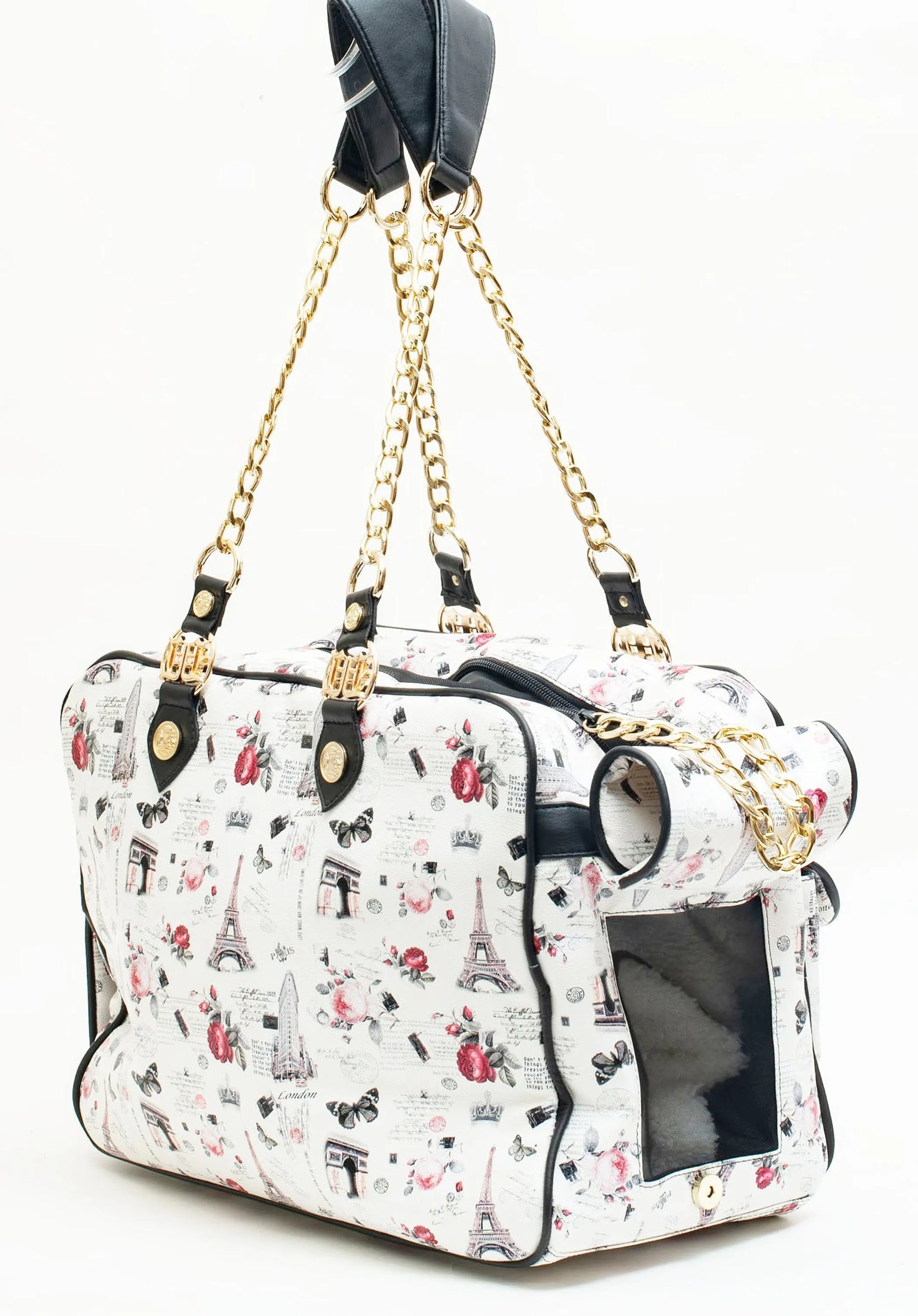 Designer pet carrier with chain strap and Paris-themed print on a white background