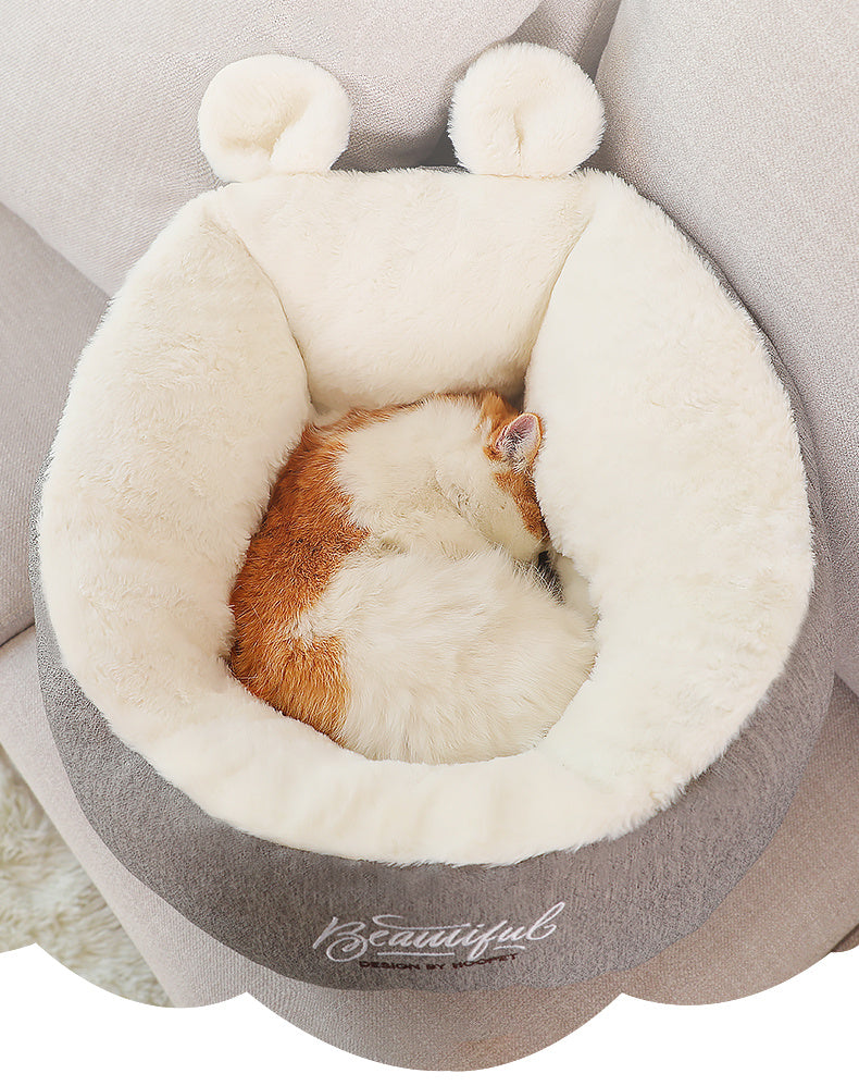 Cat in gray and ivory pet bed sleeping