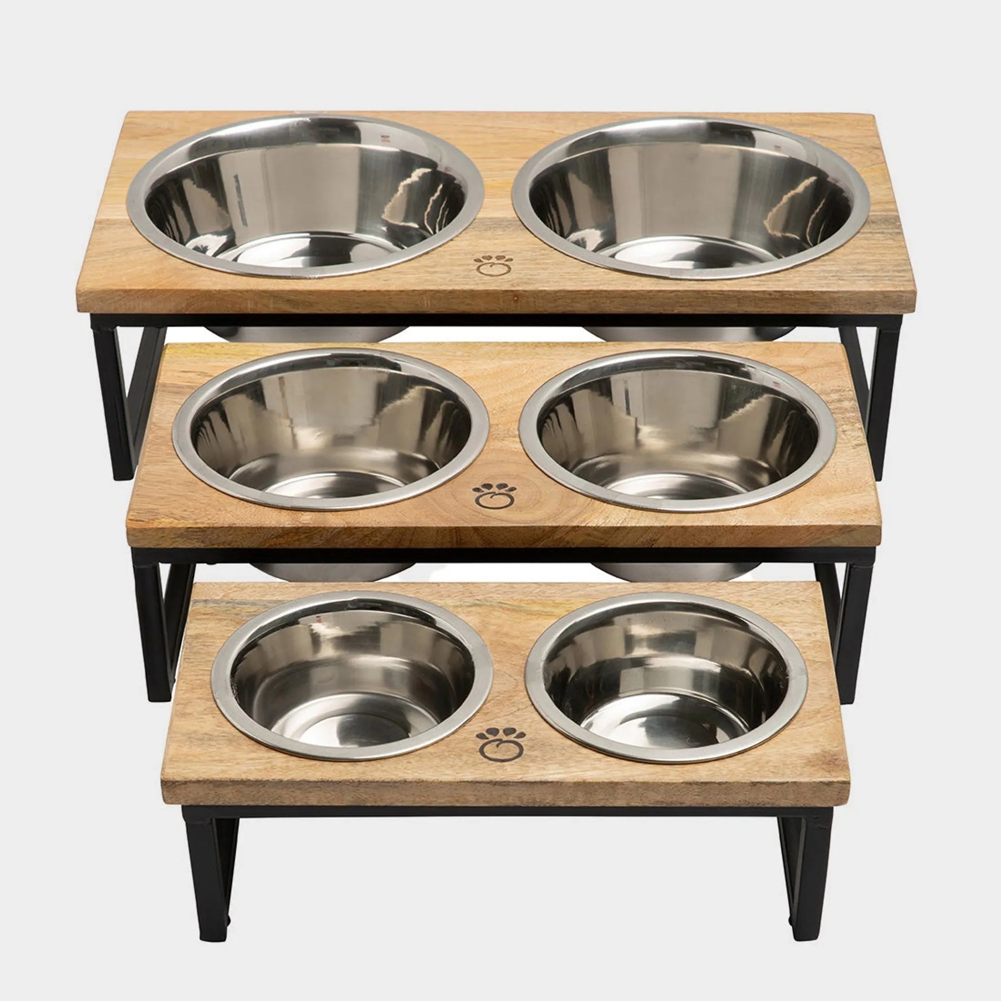 Wooden pet feeding station with four stainless steel bowls on a white background