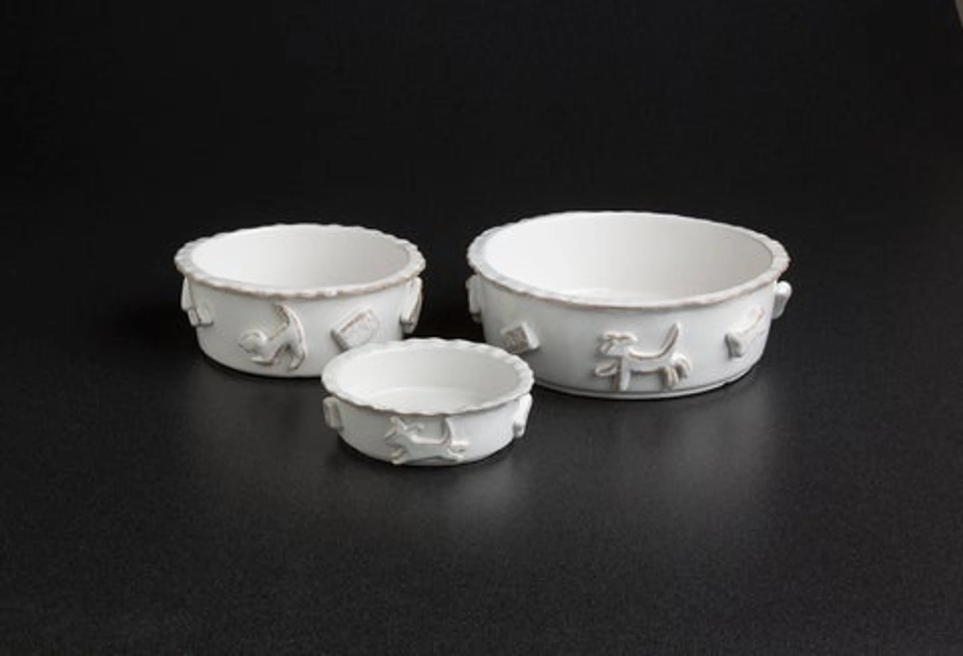 Three white ceramic bowls with textured design on a black background