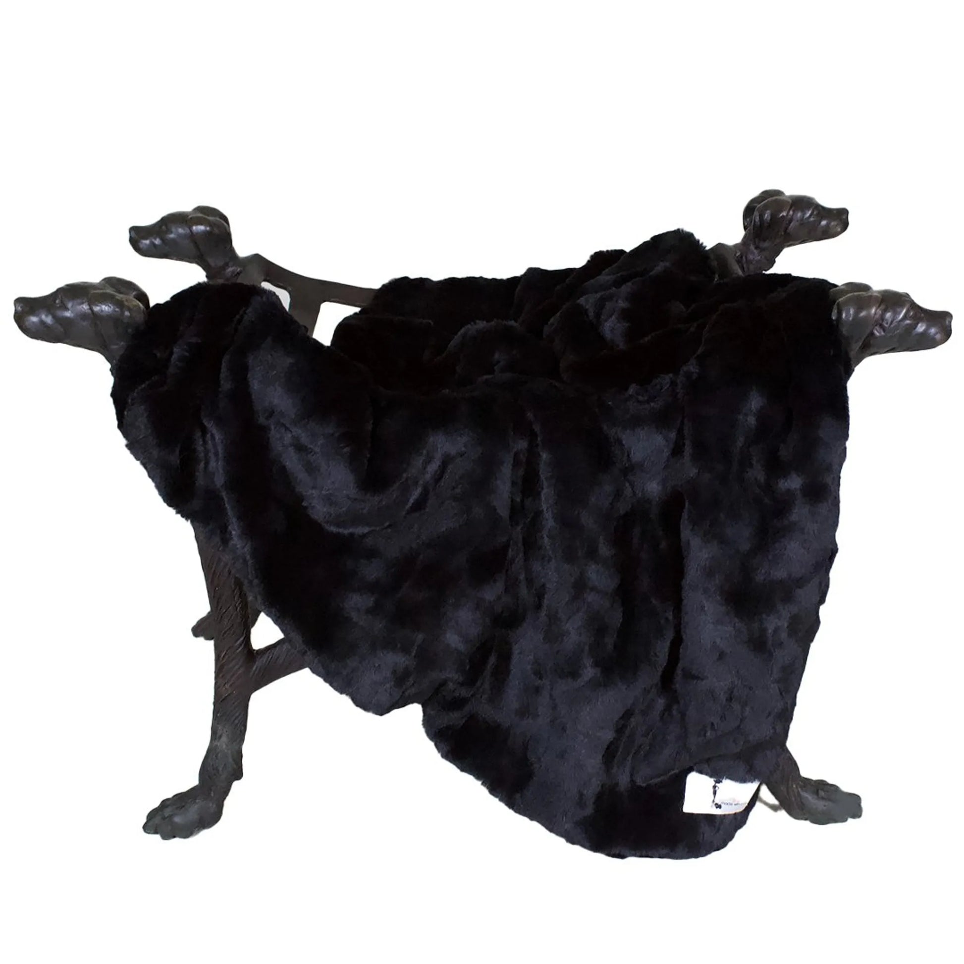 Black fur blanket draped over a decorative metal stand on a white background