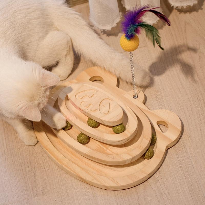 Cat playing with a wooden puzzle toy on a wooden floor