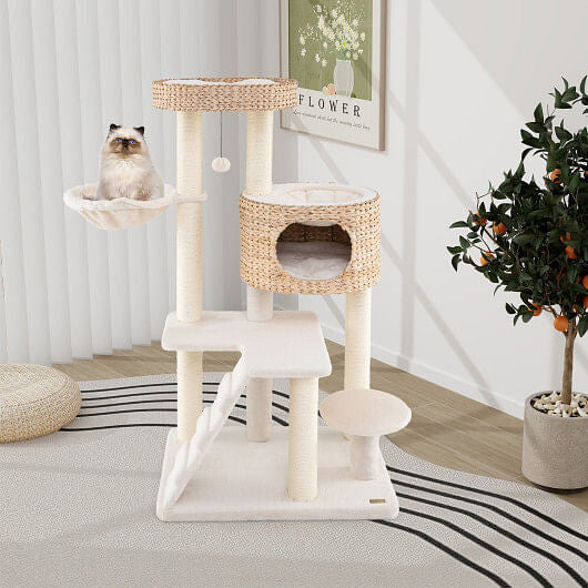 Cat tree with multiple levels and a cat sitting on one of the platforms in a room.