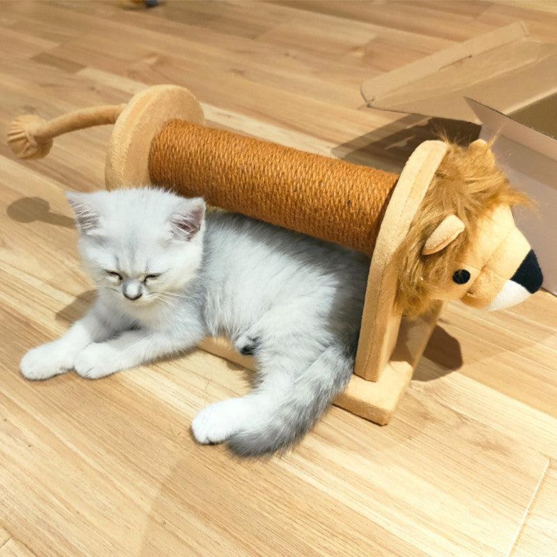 Kitten playing with a lion-shaped cat toy on a wooden floor