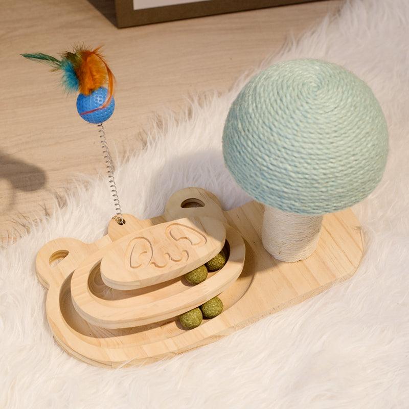 Pet toy set with wooden structure, green ball, and feather toy on a soft surface