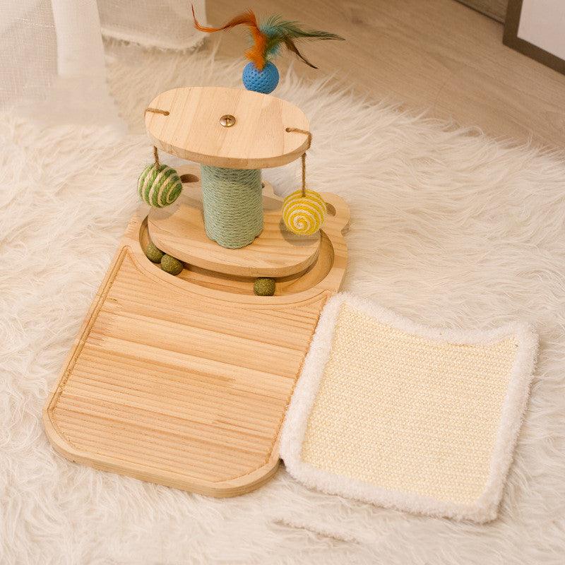 Wooden cat toy with balls and a scratching post on a fluffy white surface